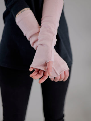 Person trägt OFF#DLY Stulpe rose - fingerlose Handschuhe, die Hand und Handgelenk umschließen, aus Viskose, Nylon und Polyester. Nahaufnahme zeigt detaillierte Struktur und Design.