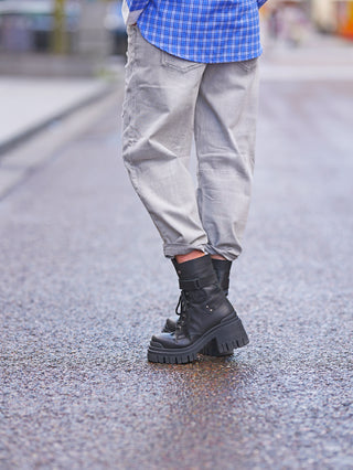 Person trägt OFF#DLY Relax Fit Destroy Denim lightgrey Jeans mit lässigem Schnitt und Destroyed-Details, kombiniert mit schwarzen Boots, ideal für modischen Streetstyle-Look.