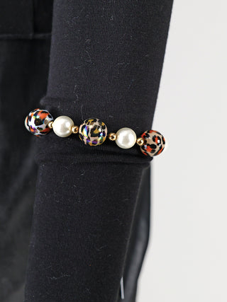 OFF#DLY Kugelarmband 15 mm multi Leo mit glänzenden, leomusterten Perlen und weißen Kunstperlen auf schwarzem Hintergrund, präsentiert als modisches Schmuckstück aus Acryl und Kupfer.