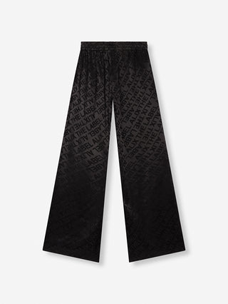 Nahaufnahme der ALIX Jacquard Pant black, einer eleganten, weiten Hose aus fließendem Jacquard-Stoff mit hohem Bund und Fronttaschen, ohne Verschluss.