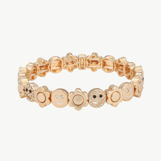 OFF#DLY Armband Smiley gold: Goldfarbiges Stretcharmband mit abwechselnden Blumen- und Smiley-Charms, einige mit klaren Kristallen besetzt, auf hellem Hintergrund flach ausgelegt. Größe: Einheitsgröße.