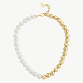 Die OFF#DLY Kugelkette KCY75 white/gold zeigt eine zweigeteilte Choker-Halskette mit weißen Kunststoffperlen auf der einen und polierten goldenen Metallperlen auf der anderen Seite, geschlossen mit einem goldenen Karabinerverschluss.