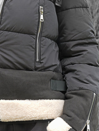OFF#DLY Jacke Canazei black: Schwarze, gesteppte Jacke mit silbernem Brustreißverschluss, verstellbarem Taillenriemen und cremefarbenem Shearling-Fleece an Saum und Bündchen. Perfekt für stilvolle Wintertage.