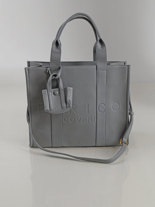 Enrico Coveri Shopper grey: Mittelgroße graue Ledertasche mit zwei kurzen Henkeln, einem verstellbaren Schulterriemen und einem kleinen, passenden Etui an einem Henkel, Markenname vorne geprägt.