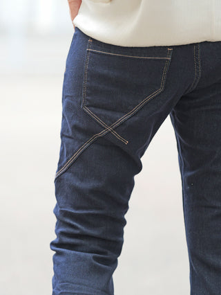 Nahaufnahme von OFF#DLY Dark Denim Luino Jeans, zeigt diagonale Ziernähte und umgeschlagenen Saum. Der moderne Schnitt und die Details betonen die Passform und Vielseitigkeit dieser vielseitigen Allround-Denim.