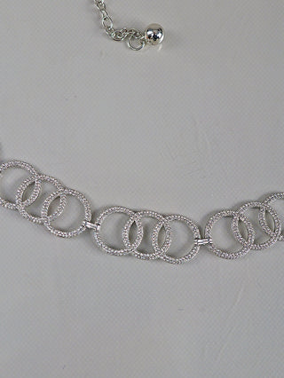OFF#DLY Kettengürtel silver/strass zeigt eine silberfarbene Kette mit funkelnden Steinen, bestehend aus ineinandergreifenden, kreisförmigen Gliedern. Mit verstellbarer Verlängerungskette und Metallperle am Ende.