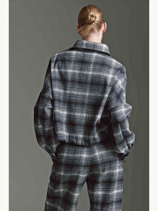 Rückansicht einer Person in einer Cotton Candy Bluse Mila multicolor. Die Bluse ist oversized, im Karo-Stil, mit Ballonärmeln und Tunnelzug, kombiniert mit einer passenden Hose.