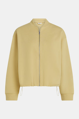 Penn&Ink Cardigan egg/white: Leichtgelber Bomber-Style, silberner Reißverschluss, gerippter Kragen und Bündchen, verstellbarer Saum mit Kordelzug, markanter Rückenprint für sportlich-modernen Look.