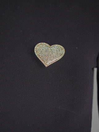 OFF#DLY Pin Heart Magnet gold: Herzförmige Brosche aus goldfarbenem Metall, besetzt mit glitzernden Steinen, auf schwarzem Stoff. Schnelles Anbringen durch Magnetfunktion. Maße: 7 cm.