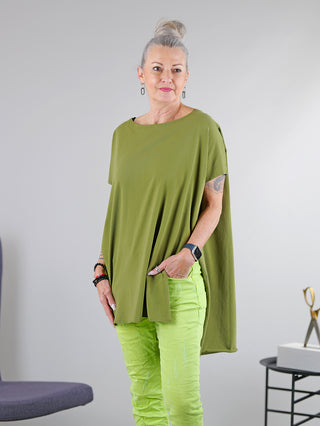 Frau trägt SOHO-t T-Shirt Mogano khaki, lässige Tunika mit seitlichem Schlitz und längerem Rückenteil. Rundhalsausschnitt, sichtbar am Arm mit einer Armbanduhr.